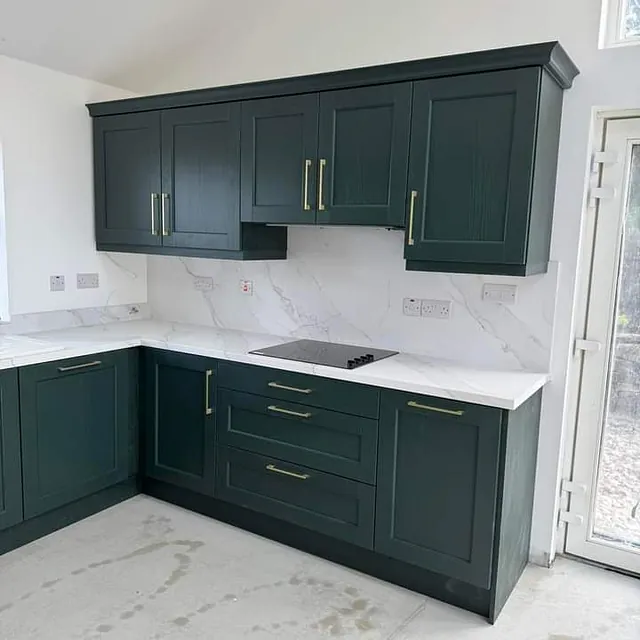 A  kitchen recently supplied by Strabane Wholesale Ltd and installed by Inside Out Creations consisting of a Bastille Evergreen Shaker Door,  Kensington brushed brass D handles, 40mm Square Edge Calacatta Olympus Worktop,  matching upstands & Splashback, Prima 1½ Bowl Ceramic Sink, Indesit Single Oven . A custom pantry unit in the utility room finishes the look.  Beautiful!!!!!